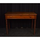 An oak rectangular topped desk, having single long drawer with turned handles on bobbin supports,