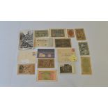 A collection of German WW2 memorabilia, including propaganda postcards, stamps, an envelope cover