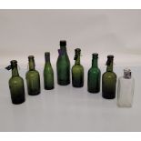 A collection of West Midlands and Shropshire glass bottles, seven green and one colourless