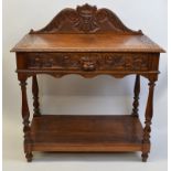 A heavily carved light oak hall table, having carved and shaped figural top rail, carved border to