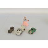 Three vintage cast metal car models, including a clockwork Londontoy model and a clockwork plastic