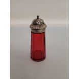 A late 19th early 20th century cranberry glass sugar sifter, with silver plated pull off lid, 14