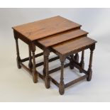An oak nest of three tables, having rectangular tops om turned legs with block feet, largest 32.