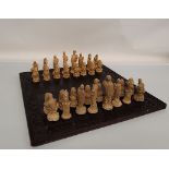 A large contemporary chess set, in varnished plaster figures modelled on the David, by Michelangelo,