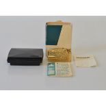 A 9ct gold Ronson lighter, having textured design to body, in box and card case with papers,