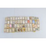 A quantity of assorted cigarette and confectionary cards, including Sweetule, Cadbury, T. Wall,