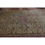 A signed Persian woollen rug, with central flower head medallion with star design, all over floral