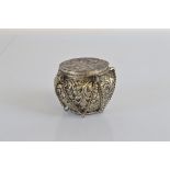 An Indian white metal lidded pot, 7cm tall.