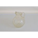 An Edwardian hand blown glass lemonade jug, with an all over punt decoration and a tapered, reeded