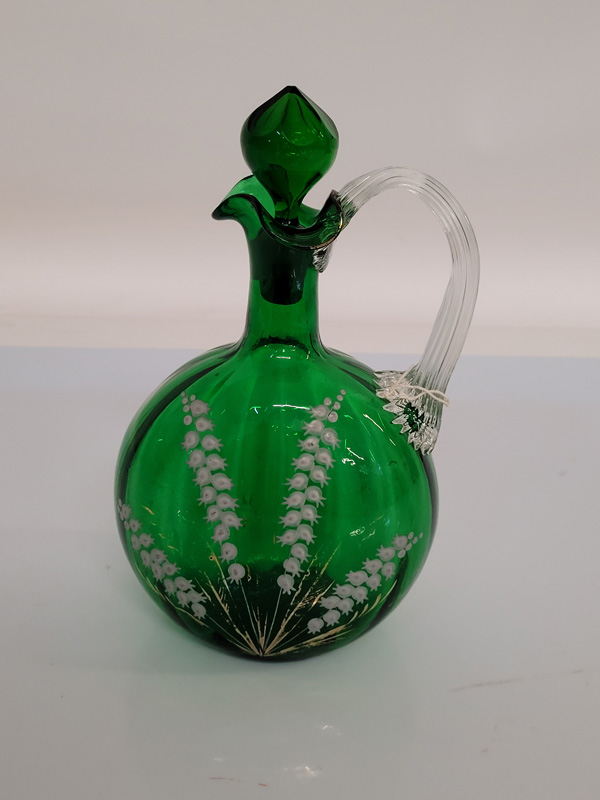 A 19th century Mary Gregory green glass and enamel decanter and stopper, with lily of the valley