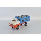 An unboxed Tri-ang TM5330 Pressed Steel Thames Trader Milk Lorry model in red, white and blue with