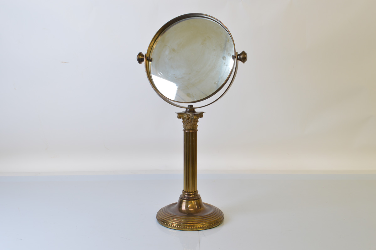 An early 20th century brass swivel mirror, 58cm tall.