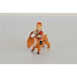 A composite toy, of Santa Claus riding a Reindeer. With tinplate Santa body, plastic head and fabric