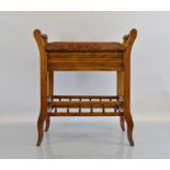 An oak framed rectangular lift top piano stool, having upholstered seat between shaped scroll