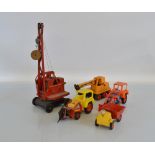 Four unboxed tri-ang Hi-Way Construction vehicles including a 'Scoop-A-Dozer' Trencher, an