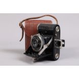 A Zeiss Ikon Baby Ikonta 520/18 Folding Camera, 3 x 4cm on 127 roll film, body F-G, wear and