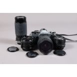 A Canon AE-1 Program SLR Body with Four Lenses, serial no 2562090, body VG, shutter working,
