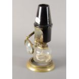 An early 20th Century brass Collins London Bockett Microscope Lamp, with Swift ceramic heat