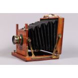 A Half Plate Mahogany and Brass Field Camera, tapered square-cornered black bellows, double