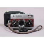 A Rollei 35 Compact Camera, chrome, brown, recovered in simulated Crocodile skin, made in Germany,