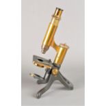A late 19th Century lacquered and anodised brass Crouch Student's Microscope, with eyepiece,