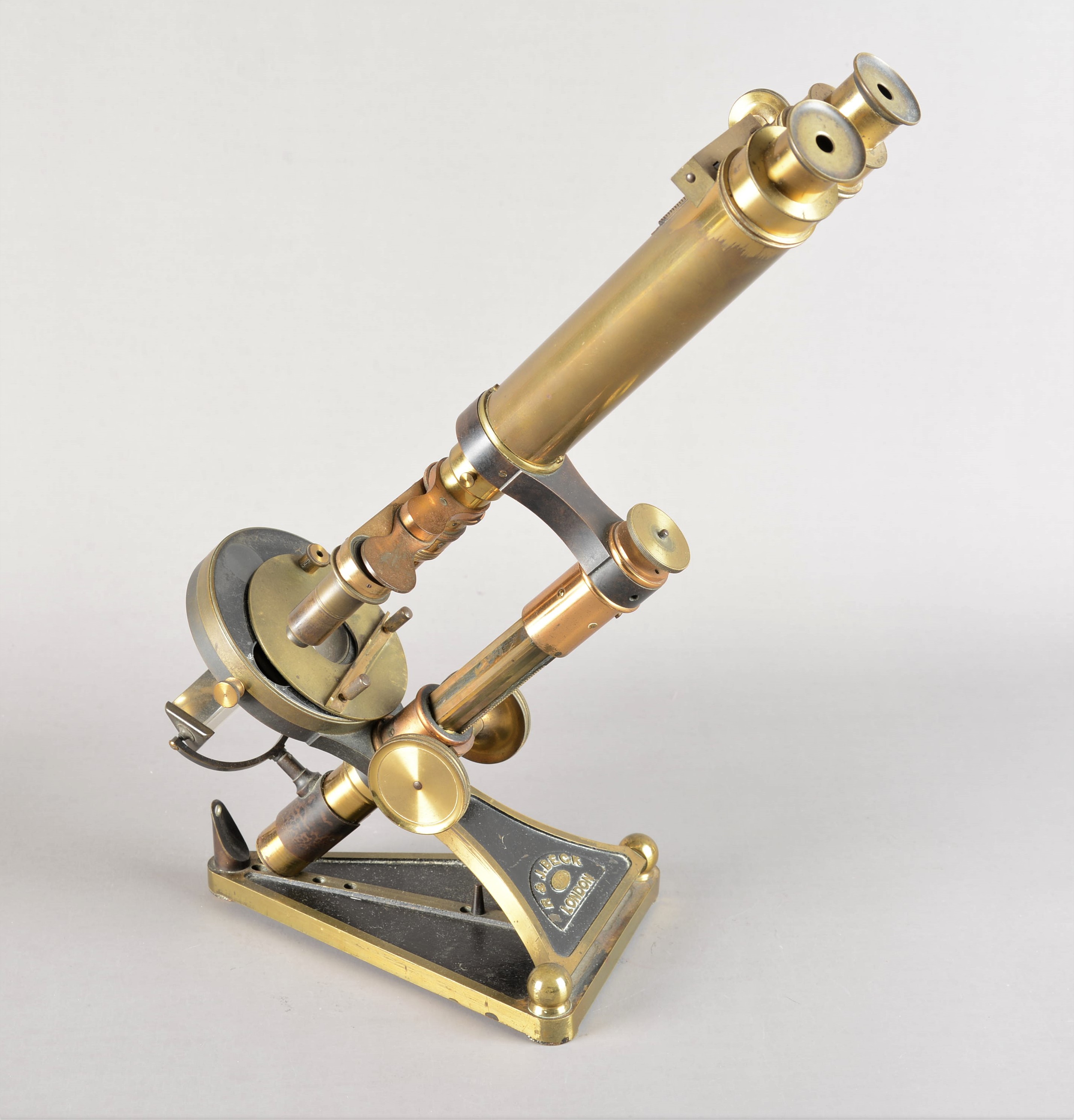 A 19th Century lacquered brass R & J Beck Popular Model Binocular Microscope, with pair of