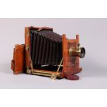 A Mahogany and Brass Half Plate Field Camera, square cornered maroon bellows, double extension, rear