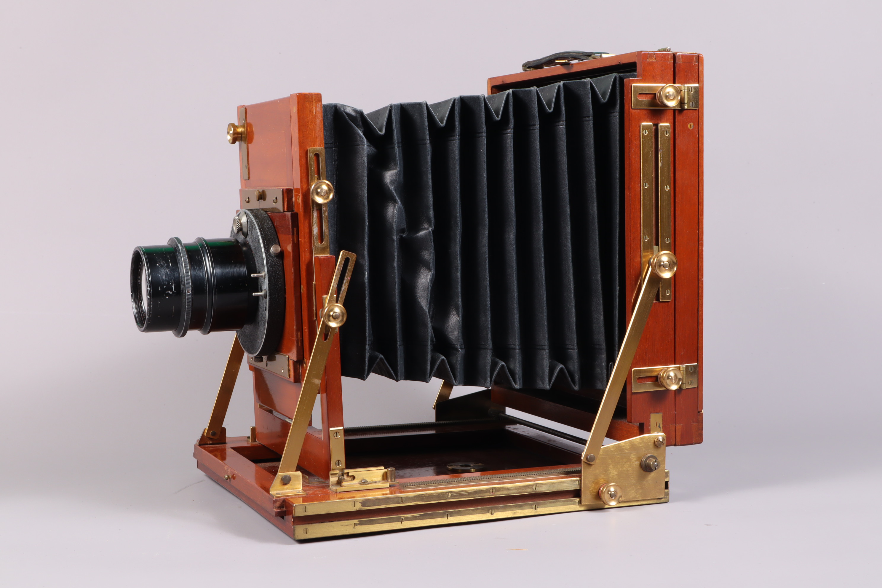 A Gandolfi Precision Half Plate Field Camera, polished mahogany body G, some marks from use, with