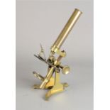 A 19th Century lacquered brass Baker Compound Monocular Microscope, with eyepiece, rack and pinion