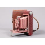 An Eastman Kodak Rainbow Hawk-Eye Vest Pocket Camera, circa 1930, red body, rose bellows for 4 x 6cm
