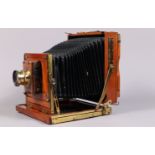 A Half Plate Mahogany and Brass Field Camera, tapered chamfered-corner black bellows, triple