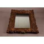 A 19th century gilt wall mirror, 45cm high, with carved frame and replaced looking glass