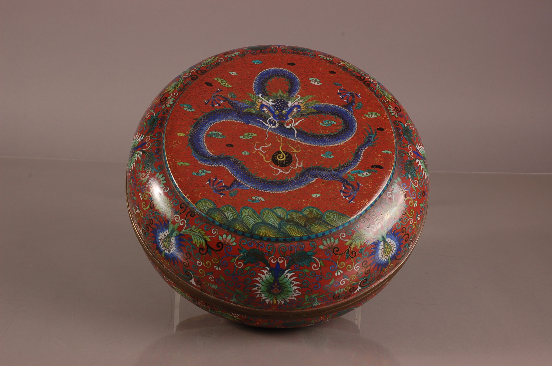 A nice early 20th century Chinese cloisonne circular box, 30cm diameter, with dragon chading flaming