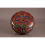 A nice early 20th century Chinese cloisonne circular box, 30cm diameter, with dragon chading flaming