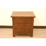 A second half 20th century hardwood bedside chest of drawers, 60cm wide, with three drawers, some