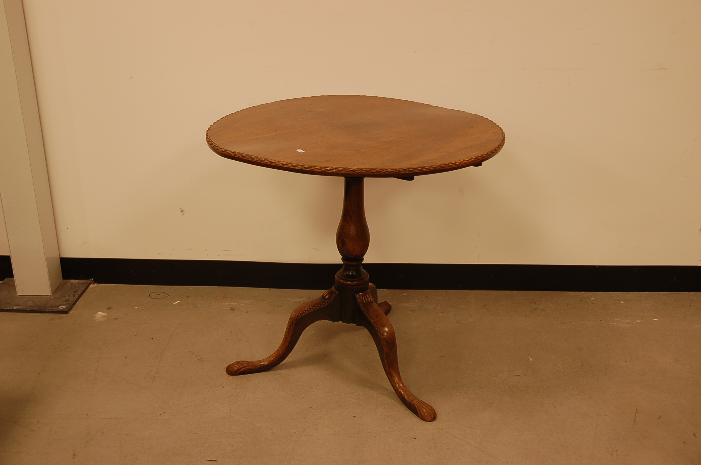 A Georgian mahogany wine table, 76cm diameter tilt top with nice carved rim on tripod base also with