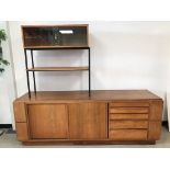 A 1960s teak veneered room divider, 224cm wide and 185cm, base damaged and AF, with five drawers and
