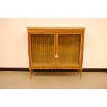 A 20th century Louis XVI style display cabinet, rectangular with applied gilt metal mounts and