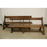 Two Victorian oak pews, on ogee arch supports with wrought iron uprights, both 183cm, probably