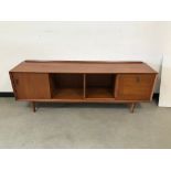 A c1960s teak sideboard, 180cm wide, door on left opening to reveal five coloured drawers, two