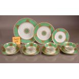 A part Wedgwood pottery dinner service, in green and white and heightened with gilt decration,