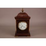 A 20th century Regeny style mantle clock, 39cm high, with brass inlay and applied finial and