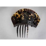 A tortoiseshell hair comb, late 19th century with one prong missing, some chipping selotape marks;