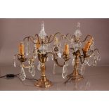 A pair of mid 20th century glass and brass lamps, three branch bases with cut glass drop pendants,