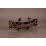 A vintage Cambodian carved hardwood kayak, 40cm, having figures to bow and stern and two figures