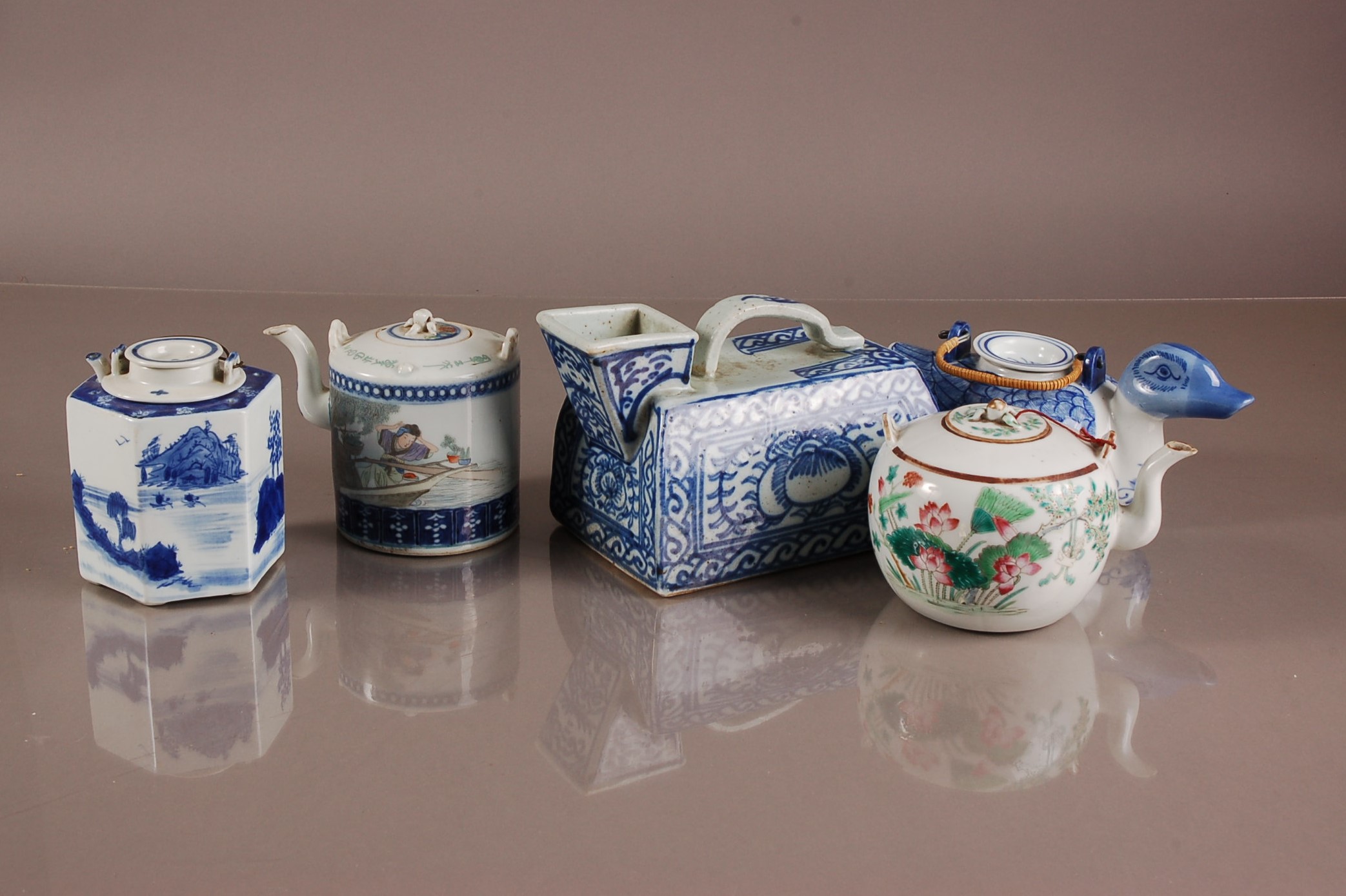 Four Oriental porcelain teapots and a Chinese porcelain iron, the blue and white Chinese porcleain