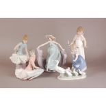 Four modern Lladro porcelain figures, including two ballerina girls, a young girl with ducks, and an