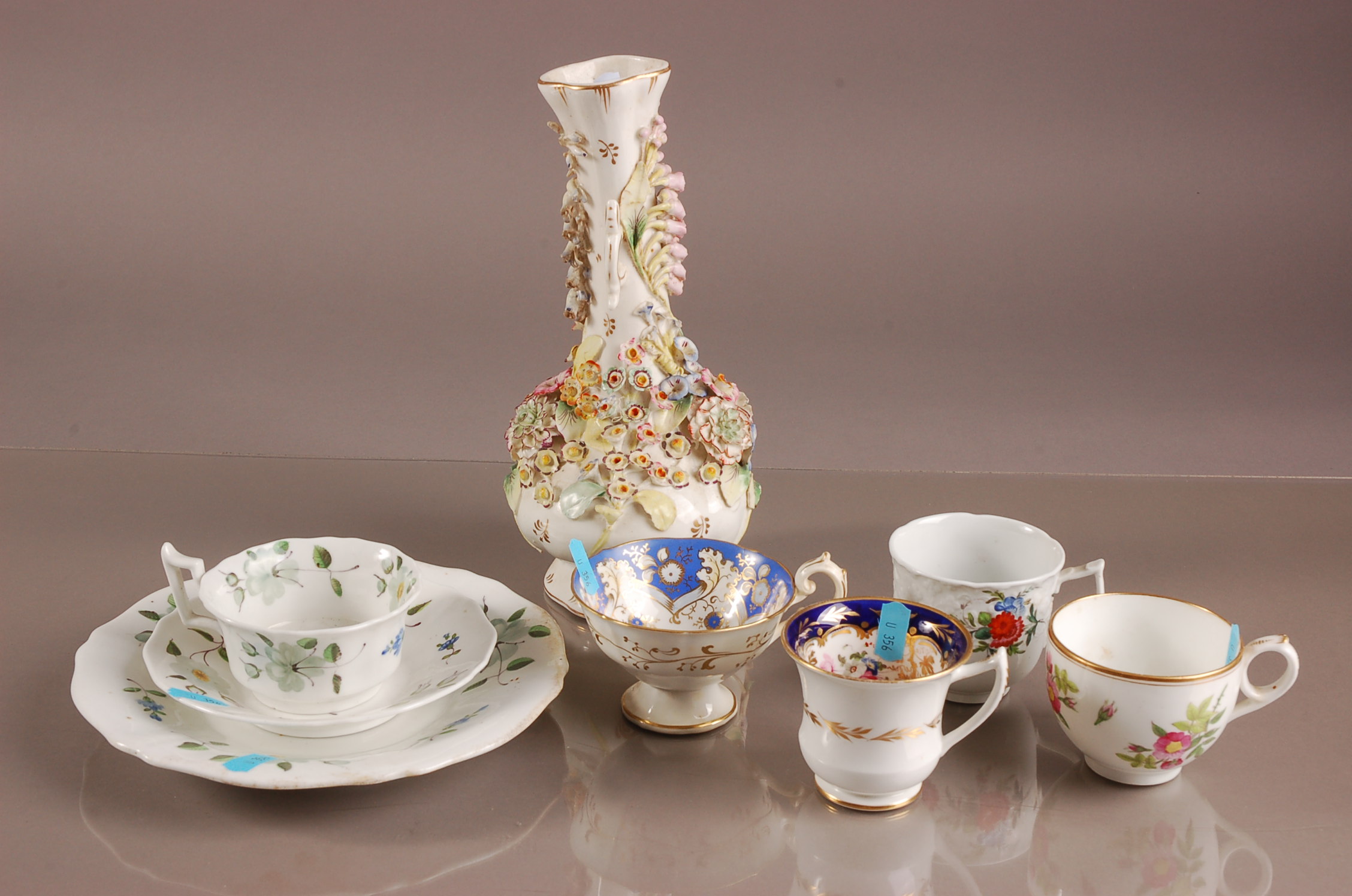 Four 19th century British porcelain tea cups, together with a cup and saucer with side plate and a