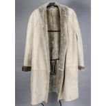A vintage white fur lady's coat, approx 120cm long, together with a sheepskin and wool coat, two fur