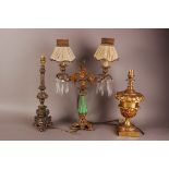Three early 20th century gilt metal lamp bases, one with triform base and in the clasical taste,